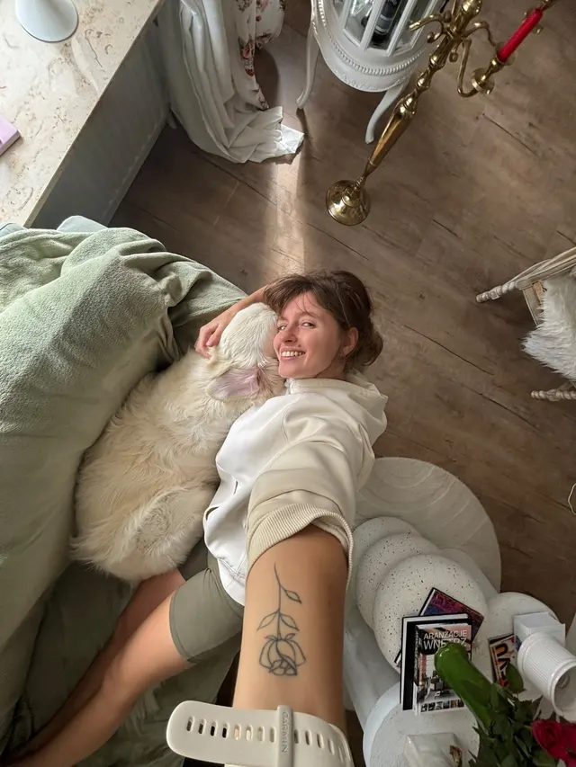 Anita, the maker behind MauHaus, lying on the floor with her dog